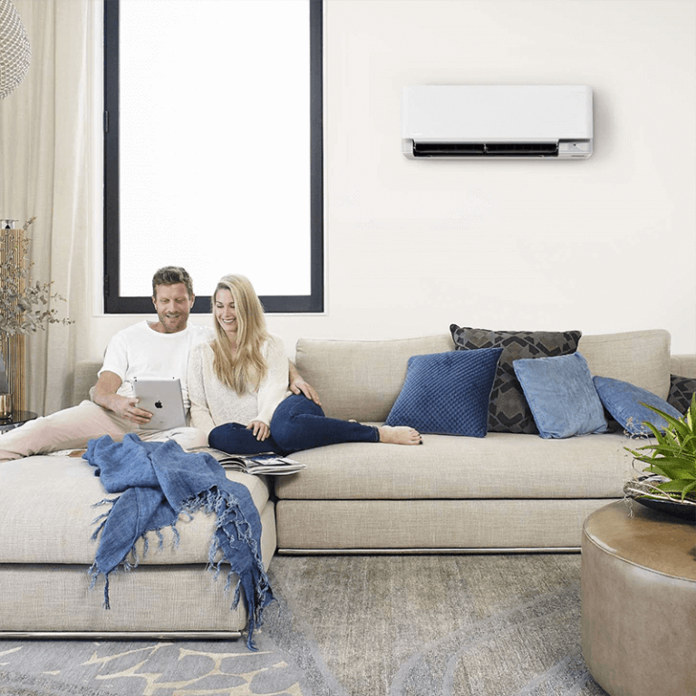 Couple laying on couch enjoying Daikin Installation of reverse cycle split system Air Conditioning unit in Gold Coast.